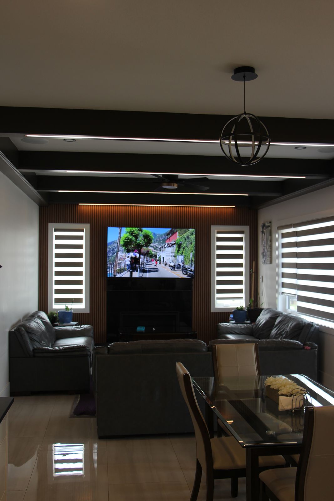 Living and dining area with warm wood ceiling detail