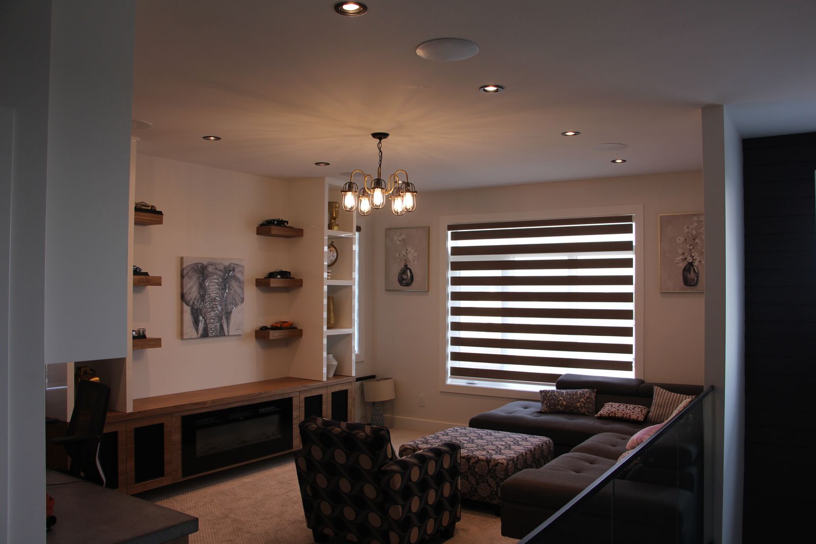 Open-concept living room with linear fireplace and custom millwork