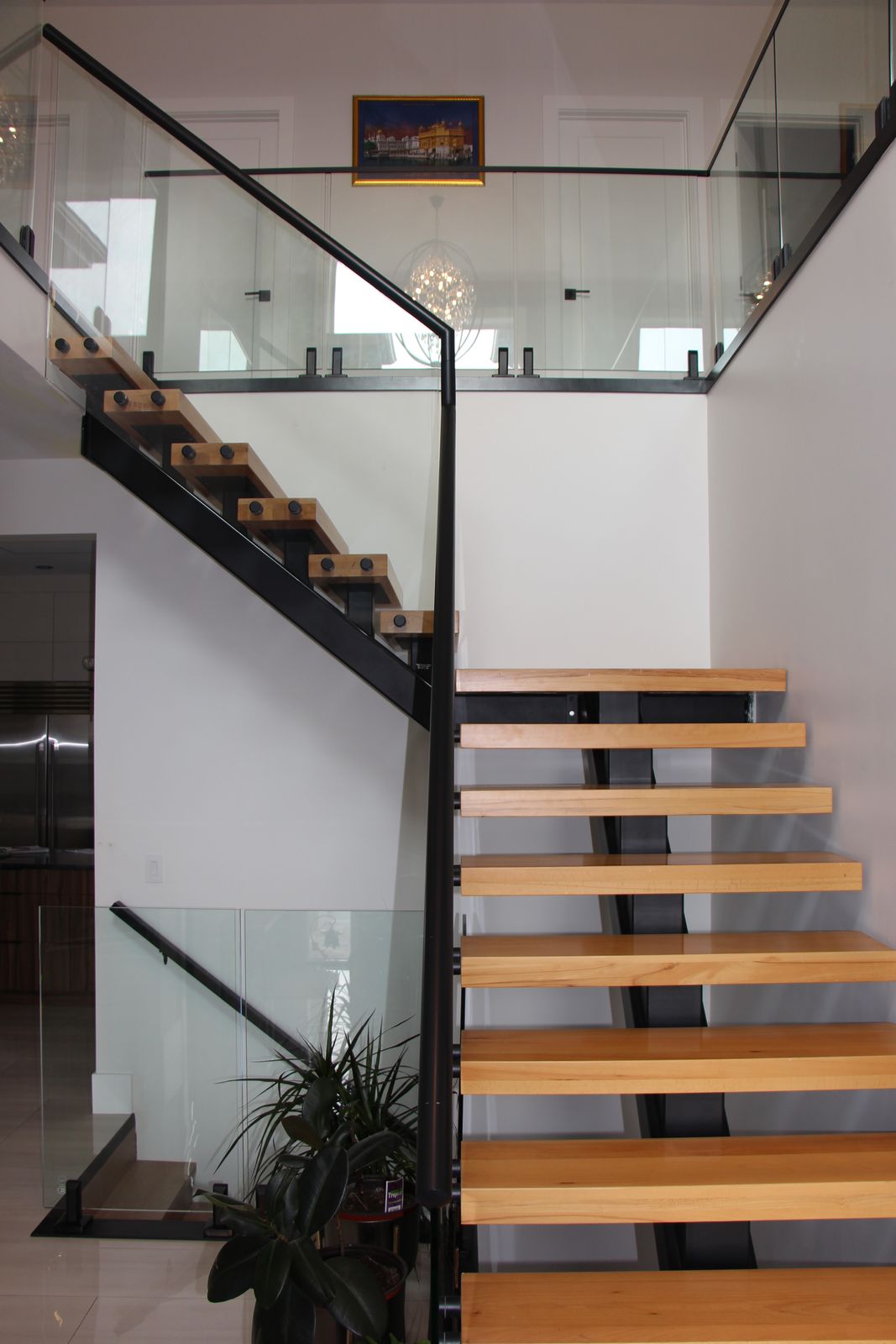 Oak treads and glass railing detail on the main staircase