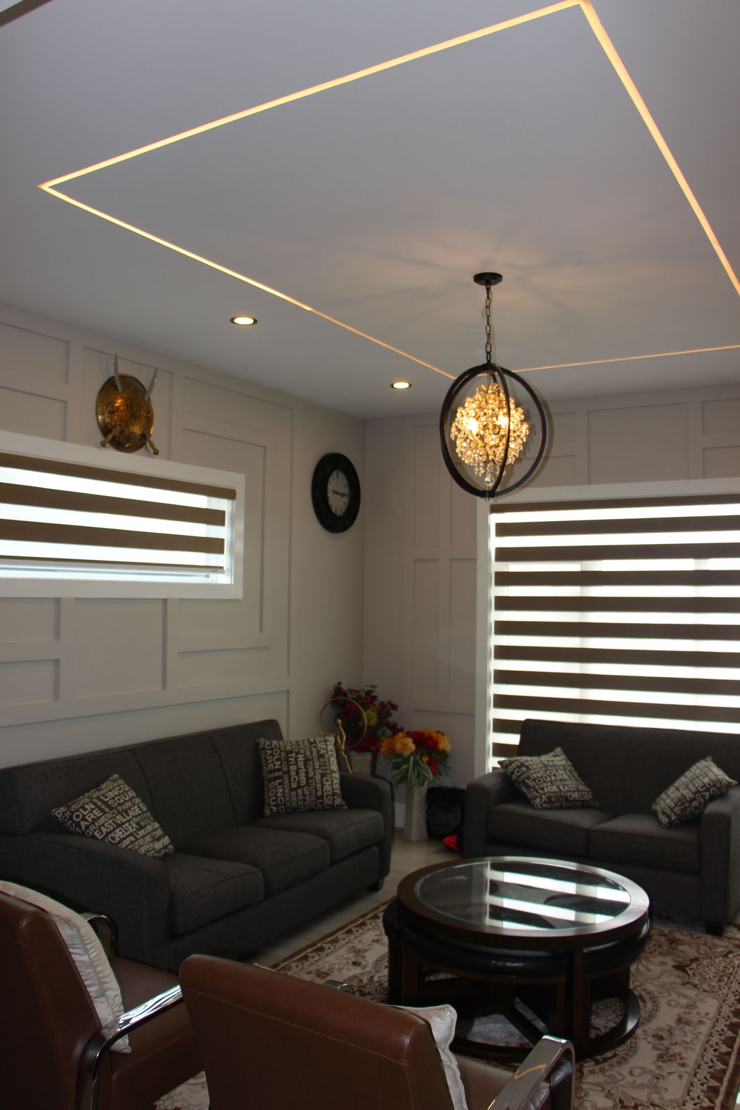 Sitting room with coffered ceiling and pendant lighting